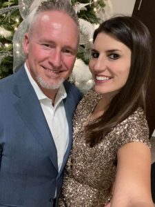 Alicia Linklater smiling with husband Mike Penny at century 21 B.J Roth office christmas party - 2019