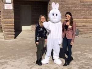 Alicia Linklater and Alana Myers posing with easter bunny mascot at annual easter egg hunt