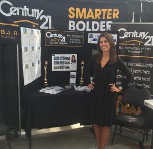 Alicia Linklater posing in front of century 21 booth at Barrie home and lifestyle show - 2016