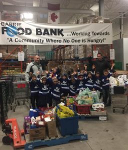 group photo at barrie food bank with barrie timbits hockey team